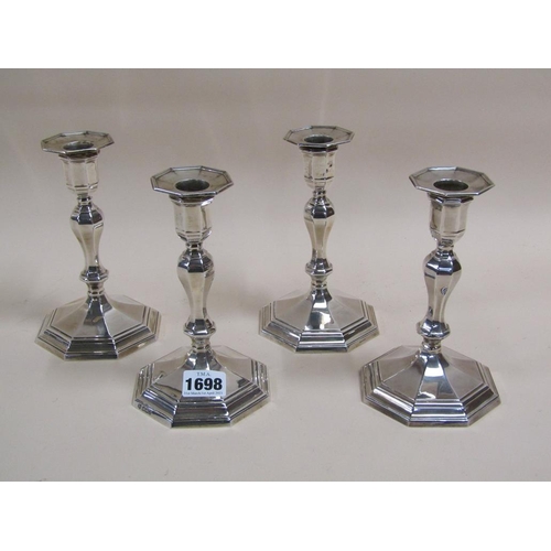 1698 - SET OF FOUR SILVER CASED CANDLESTICKS - 17cms H