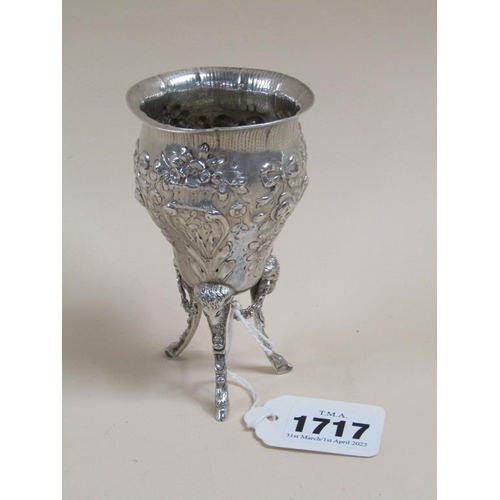 1717 - SILVER EMBOSSED AND CHASED OVOID SHAPED VASE SUPPORTED ON THREE LEGS WITH RAMS HEAD TERMINALS, 10.5C... 