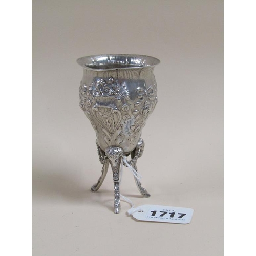 1717 - SILVER EMBOSSED AND CHASED OVOID SHAPED VASE SUPPORTED ON THREE LEGS WITH RAMS HEAD TERMINALS, 10.5C... 