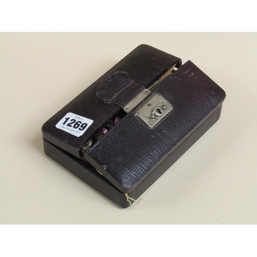 1269 - BLACK LEATHER TRAVELLING JEWEL BOX TOGETHER WITH THE MISC. CONTENTS