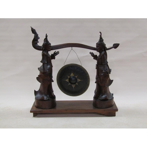 285 - A late 19c/early 20c Oriental hardwood dinner gong stand in the form of two Siamese figures supporti... 