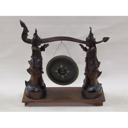 285 - A late 19c/early 20c Oriental hardwood dinner gong stand in the form of two Siamese figures supporti... 