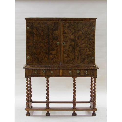 286 - An 18c oyster veneer cabinet on stand, the cabinet under a shallow moulded cornice enclosed by two h... 