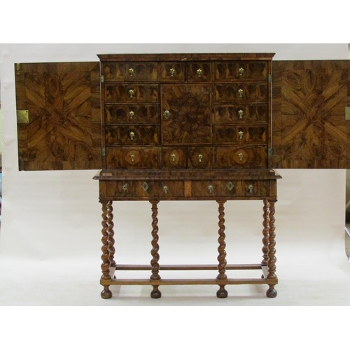 286 - An 18c oyster veneer cabinet on stand, the cabinet under a shallow moulded cornice enclosed by two h... 