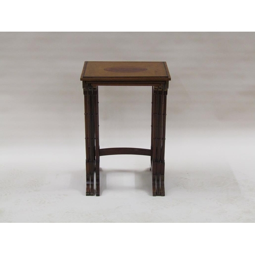 296 - A 19c nest of three figure mahogany occasional tables, the table tops with oval motifs, supported on... 