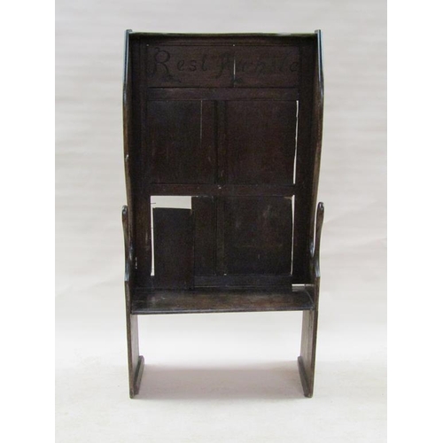 304 - An 18c oak high wingback settle, the top panel carved 'Rest awhile', 83.5cm w, 160cm h.