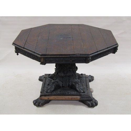 306 - An early 19c oak centre table of octagonal form, the table top carved with a central sunburst and su... 