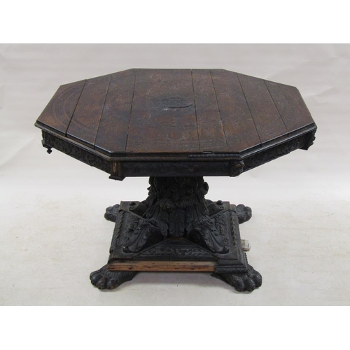 306 - An early 19c oak centre table of octagonal form, the table top carved with a central sunburst and su... 