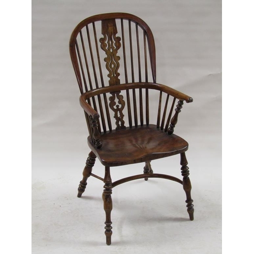 309 - A 19c Windsor ash and elm hooped spindle back armchair with crinoline stretchers supported on ring t... 