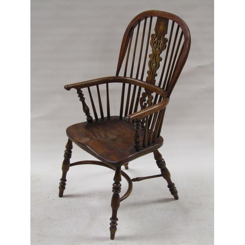 309 - A 19c Windsor ash and elm hooped spindle back armchair with crinoline stretchers supported on ring t... 