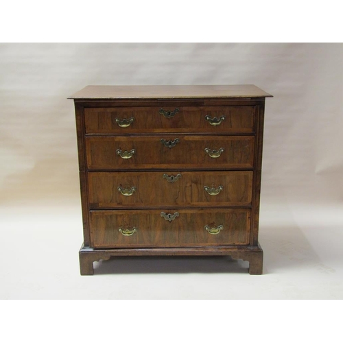 312 - An 18c oak chest of three long graduated drawers, the drawer fronts veneered and crossbanded in waln... 