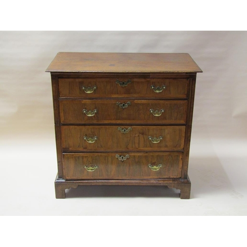 312 - An 18c oak chest of three long graduated drawers, the drawer fronts veneered and crossbanded in waln... 