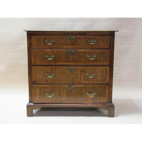 312 - An 18c oak chest of three long graduated drawers, the drawer fronts veneered and crossbanded in waln... 