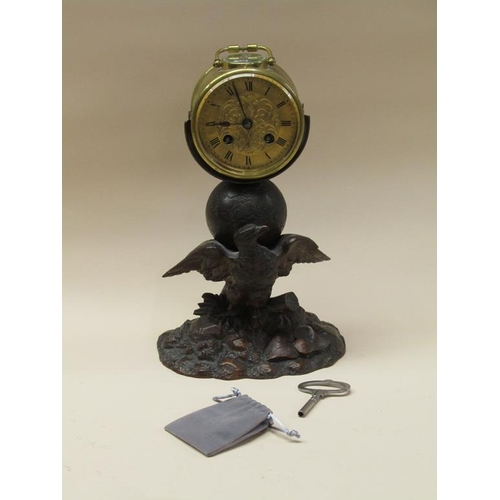 33 - A late 19c French drum mantel clock mounted on a carved wood stand (possibly Black Forest) depicting... 