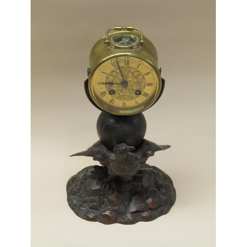 33 - A late 19c French drum mantel clock mounted on a carved wood stand (possibly Black Forest) depicting... 