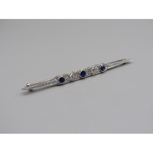 102 - An Art Deco period platinum diamond and sapphire set bar brooch, 7cm w.