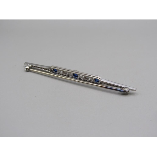 102 - An Art Deco period platinum diamond and sapphire set bar brooch, 7cm w.