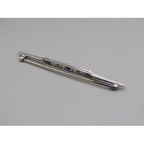 102 - An Art Deco period platinum diamond and sapphire set bar brooch, 7cm w.