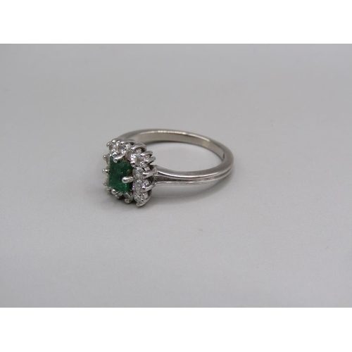 108 - A platinum diamond and emerald set ring, size L.