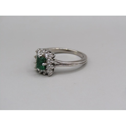 108 - A platinum diamond and emerald set ring, size L.