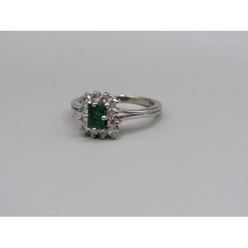 108 - A platinum diamond and emerald set ring, size L.