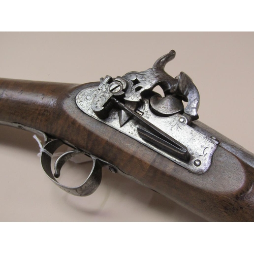 14 - A European flint lock blunderbuss with a 12in steel barrel with flared oval muzzle, carved full stoc... 