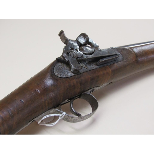 14 - A European flint lock blunderbuss with a 12in steel barrel with flared oval muzzle, carved full stoc... 