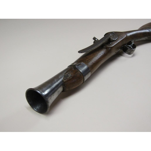 14 - A European flint lock blunderbuss with a 12in steel barrel with flared oval muzzle, carved full stoc... 