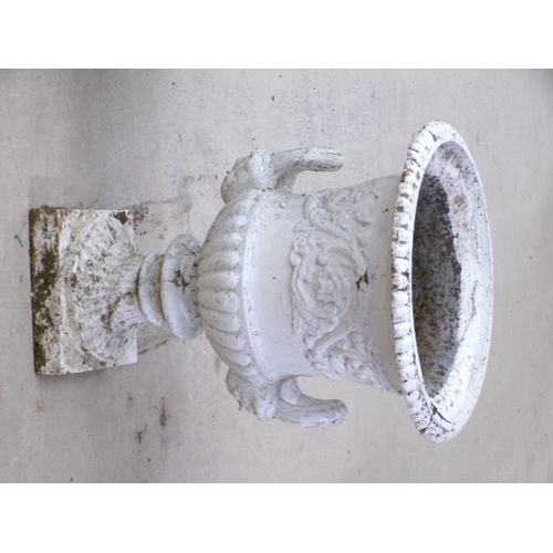 25 - A pair of cast iron campagna shaped urns, two handled, later white painted, on ring cast circular ba... 