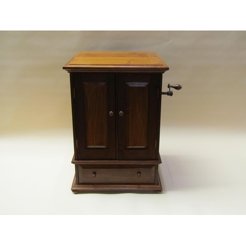 57 - An early 20c German Polyphon by Schutz Marke in a mahogany cabinet case with front opening doors and... 