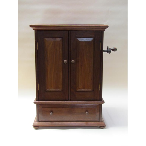 57 - An early 20c German Polyphon by Schutz Marke in a mahogany cabinet case with front opening doors and... 