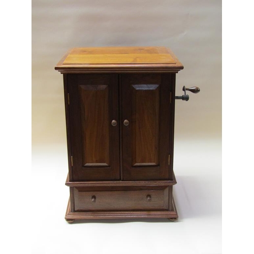 57 - An early 20c German Polyphon by Schutz Marke in a mahogany cabinet case with front opening doors and... 