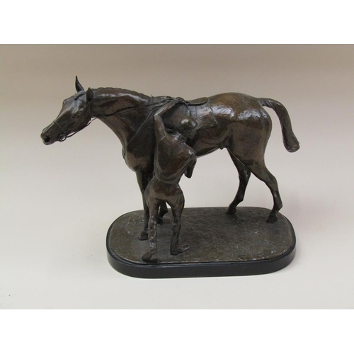 65 - A patinated bronze of a jockey about to mount a horse, the base inscribed J Walwyn 1961, and support... 