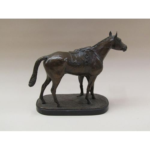 65 - A patinated bronze of a jockey about to mount a horse, the base inscribed J Walwyn 1961, and support... 