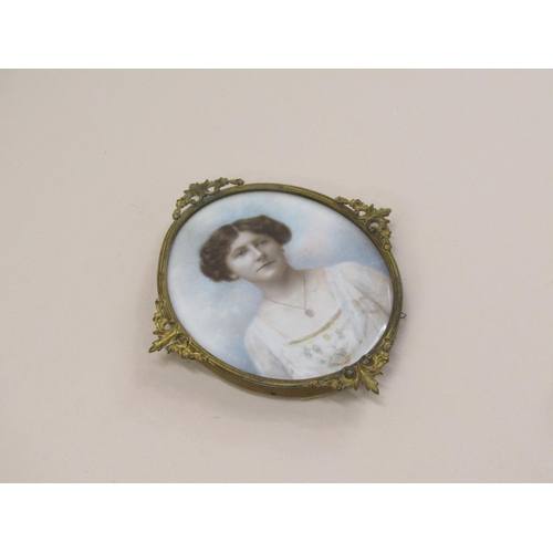 80 - A late 19c/early 20c portrait miniature of a lady, on paper, oval gilt metal frame, 10cm x 9cm.