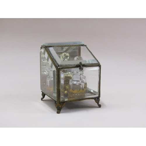 87 - A late Victorian glass scent bottle stand containing three glass bottles, with bevel edge glass wind... 