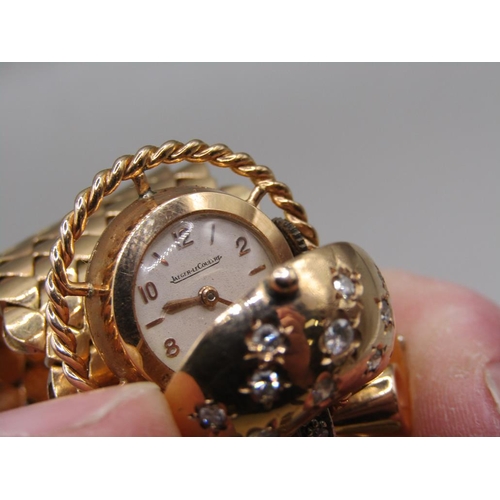 95 - A Jaeger Le Coultre gold bracelet watch in the form of a belt buckle, diamond set to the hinge watch... 