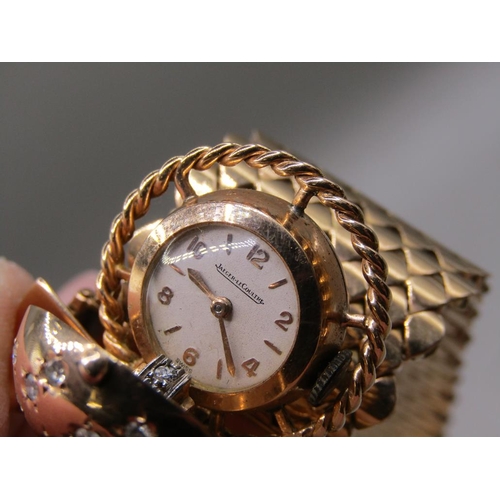 95 - A Jaeger Le Coultre gold bracelet watch in the form of a belt buckle, diamond set to the hinge watch... 