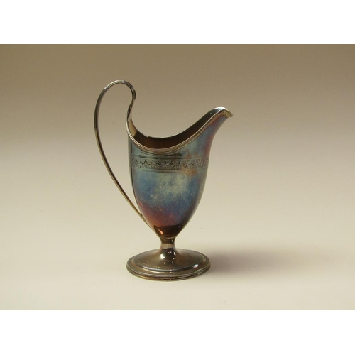 144 - A George III silver cream jug with threaded upper rim and handle on an oval stepped base, London 179... 