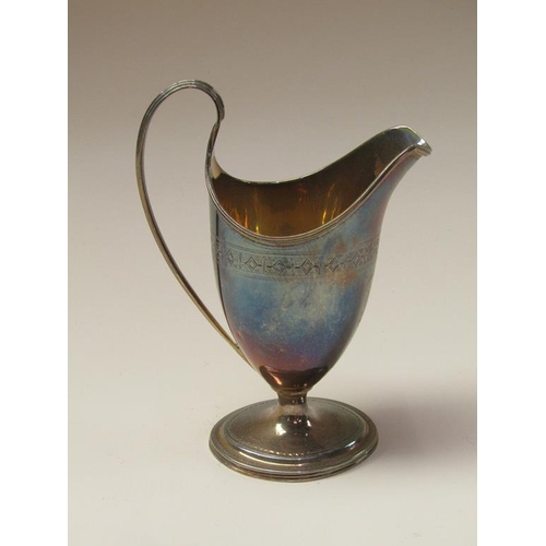 144 - A George III silver cream jug with threaded upper rim and handle on an oval stepped base, London 179... 