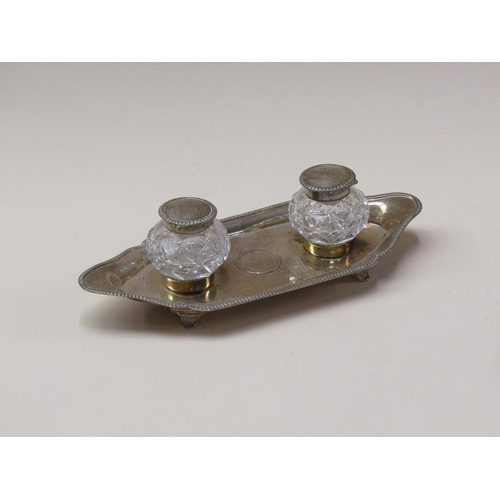 154 - A late Victorian two bottle inkstand, the stand with a raised gadroon cast border, London 1898, with... 