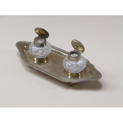 154 - A late Victorian two bottle inkstand, the stand with a raised gadroon cast border, London 1898, with... 