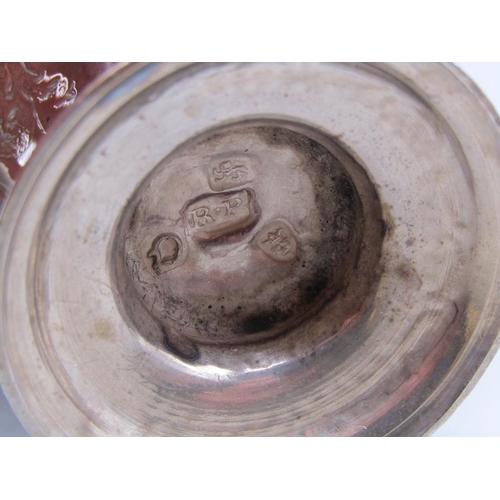 146 - A George III silver pepper with a pierced dome cover and flame finial, having an embossed and chased... 