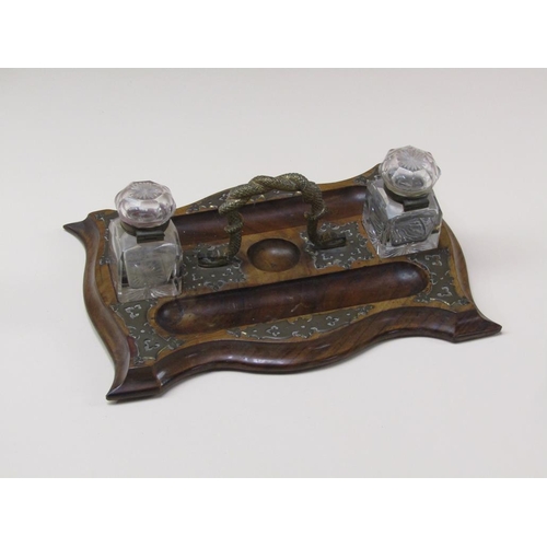 70 - A Victorian walnut brass mounted two bottle inkstand, the central gilt metal carrying handle cast as... 