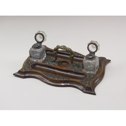 70 - A Victorian walnut brass mounted two bottle inkstand, the central gilt metal carrying handle cast as... 