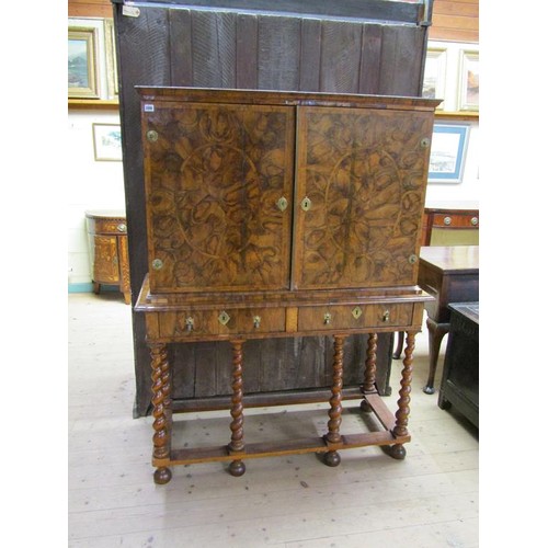 286 - An 18c oyster veneer cabinet on stand, the cabinet under a shallow moulded cornice enclosed by two h... 