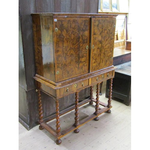 286 - An 18c oyster veneer cabinet on stand, the cabinet under a shallow moulded cornice enclosed by two h... 