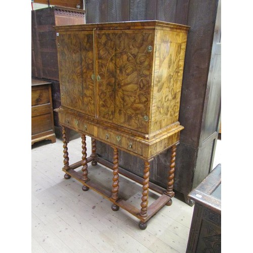 286 - An 18c oyster veneer cabinet on stand, the cabinet under a shallow moulded cornice enclosed by two h... 