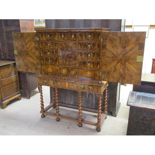 286 - An 18c oyster veneer cabinet on stand, the cabinet under a shallow moulded cornice enclosed by two h... 