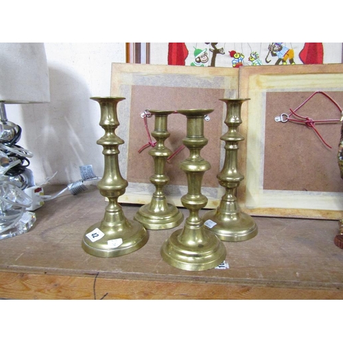 42 - TWO PAIRS ON ANTIQUE BRASS CANDLESTICKS